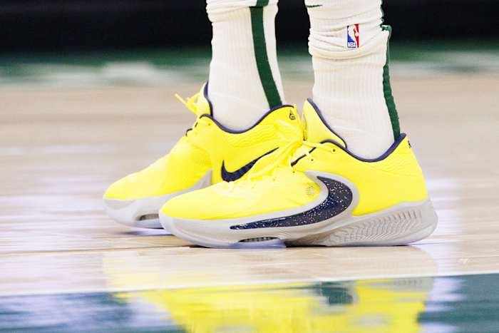View of Giannis Antetokounmpo's yellow and black Nike shoes.